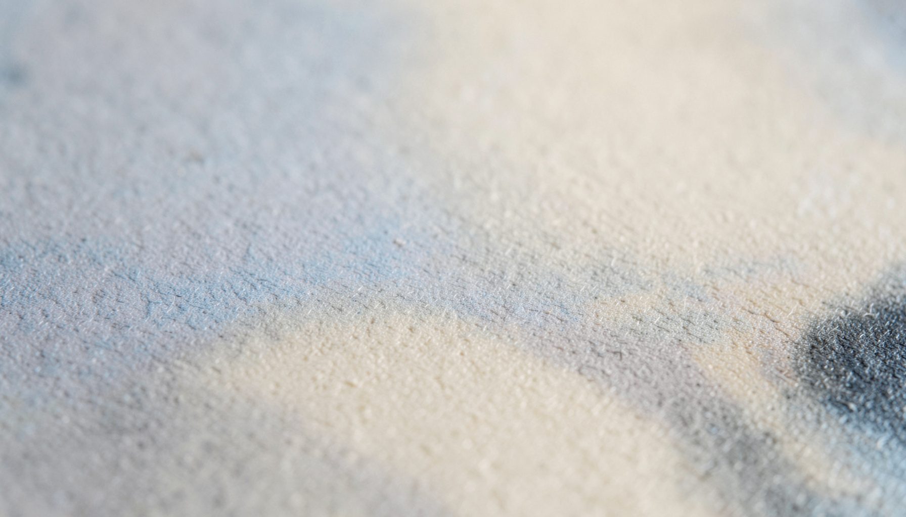 A wide atmospheric photograph of a calm, neutral-toned abstract surface with soft beige and charcoal gradients